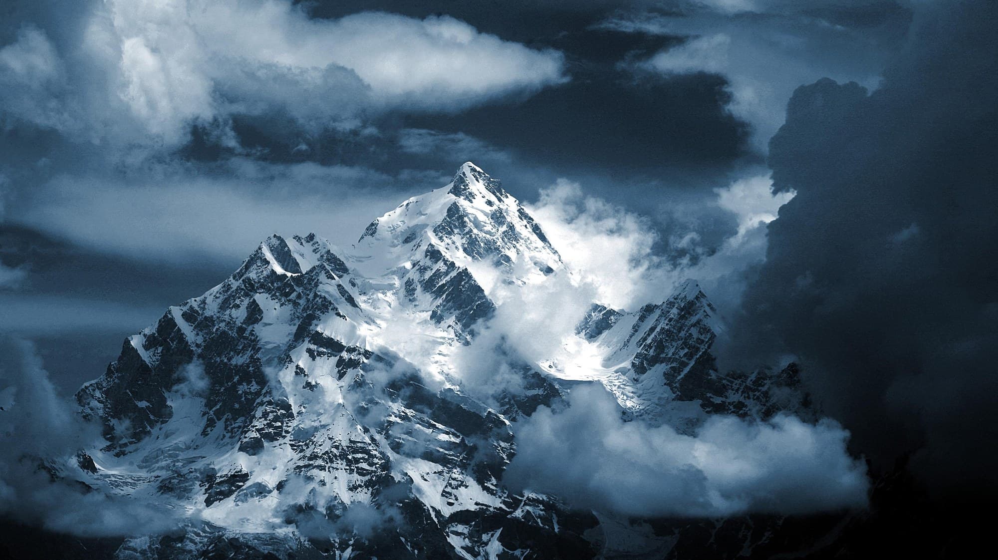 Nanga Parbat, a snow peak breaking through cloud.